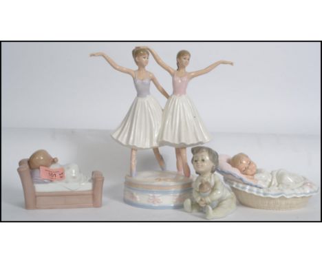 A collection of Nao and other ceramic figurines of children along with a pair of ballet dancers on a ceramic plinth base. Mea