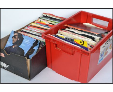 A collection of vinyl  7" singles dating from the 1960's to include several artists such as George Harrison, Debbie Harry, No