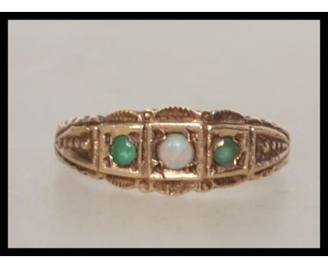 A 9ct gold ladies peridot and opal 3 stone ring having gypsy style setting. Total weight 2.3g / Size N  