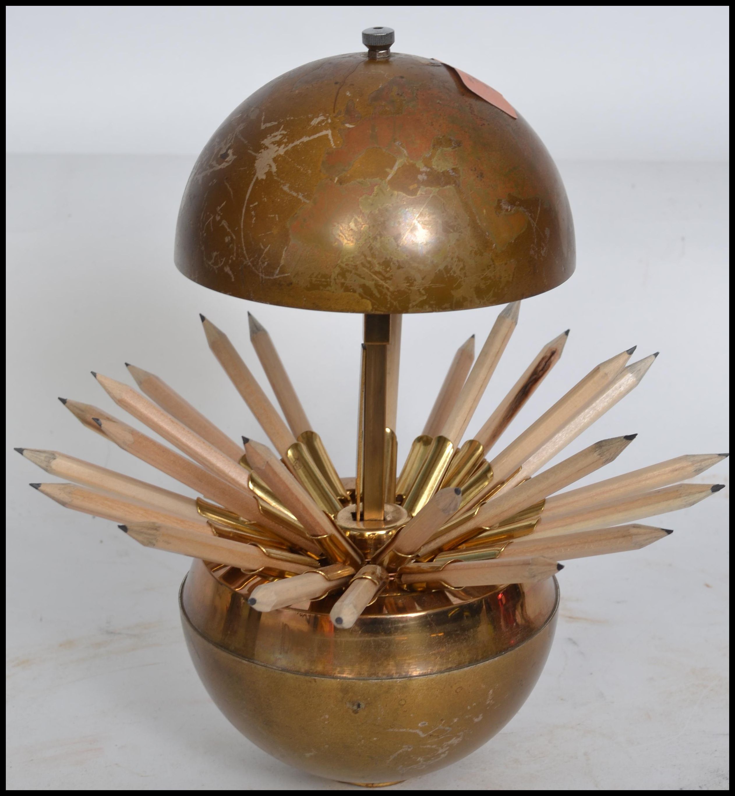 A 1950's retro spherical cigarette dispenser having metamorphic action