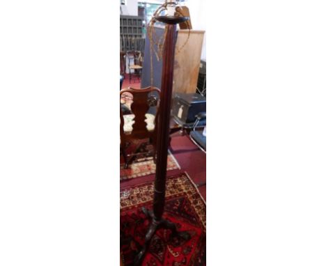 A 19th century mahogany torchere stand, converted into a standard lamp, raised on ball and claw feet 
