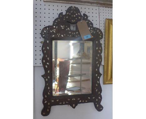 An early 1900s Liberty Syrian wall mirror, the bevelled glass plate within a mother of pearl inlaid hardwood frame, H.66cm W.