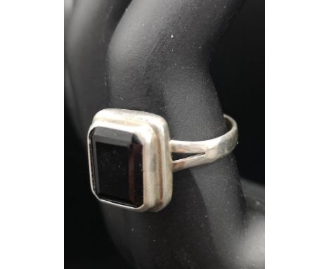 Silver ring set with black stone. 