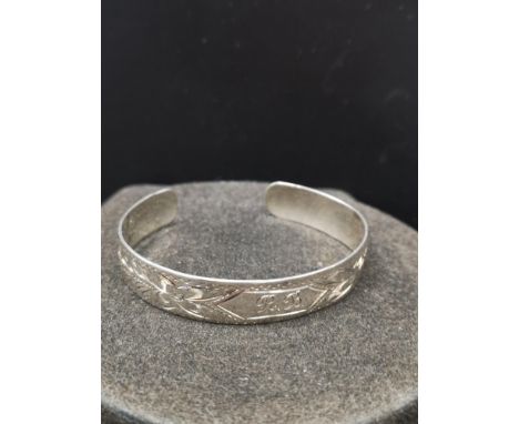 Sterling silver slave style bangle marked sterling +w+. 