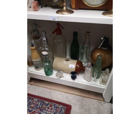 Shelf of old bottles, soda syphine, ginger beer stone ware bottle. Etc. 