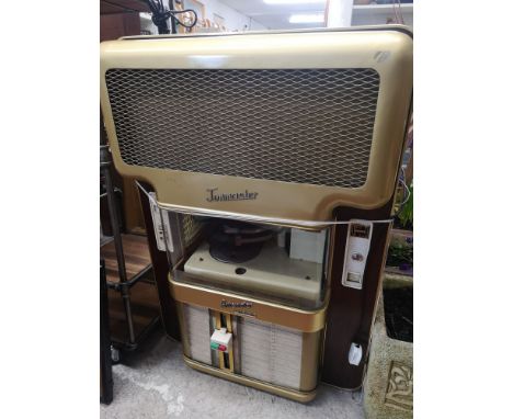 Large retro 1960s wall mounted jukebox with records does light up. 