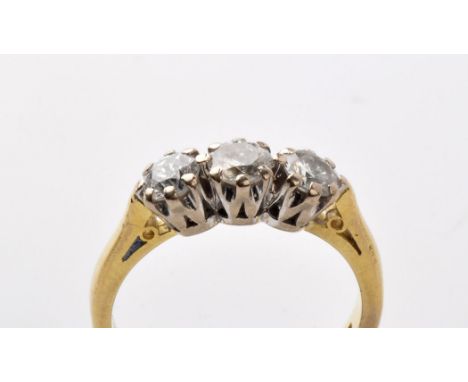 A three stone diamond ring, the brilliant cut diamonds weighing a total of approximately 0.75 carats, crown mount above cheni