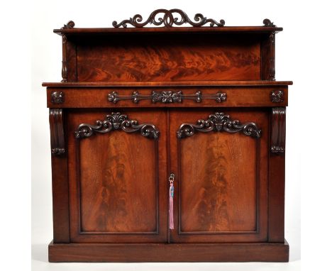 A Victorian mahogany chiffonier, with raised shelf above a single frieze drawer, a pair of panel doors below decorated with a