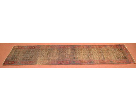 A Persian Bijar runner, the central field with stylized decoration and geometric foliate border surround, 202 x 46in. (512 x 