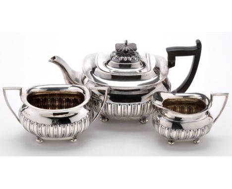 An early 20th Century three-piece tea service, by Walker & Hall, Sheffield 1908 and 1910, of shaped oval half fluted form, en