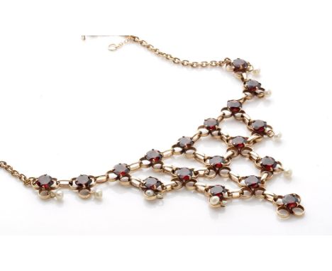 A garnet and seed pearl fringe necklace, facet cut garnets set, surround by seed pearl drops, on 9ct. yellow gold oval link c