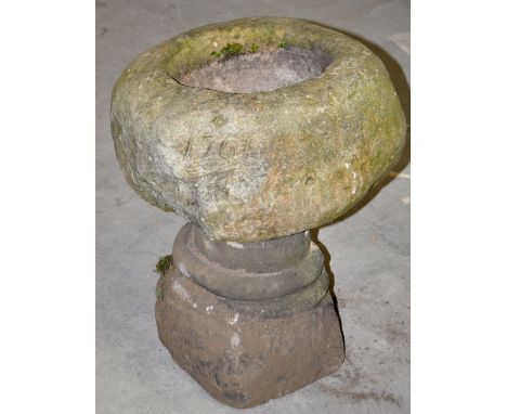 An 18th Century stone trough, the circular well date 1797 standing on a carved pedestal, 23in. high.