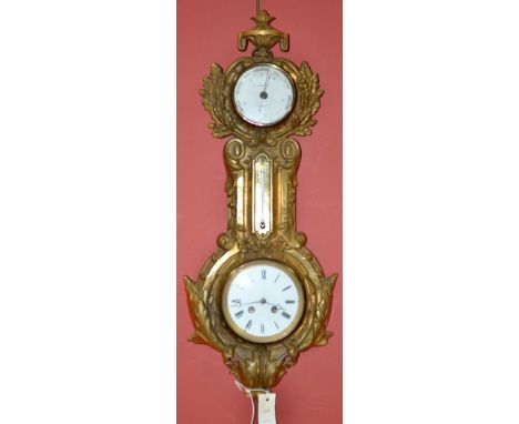 A late 19th Century gold painted cast iron clock and barometer, the barometer by J.J. Wainwright, Birmingham, centred by a th