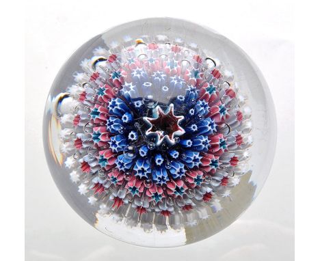 Starburst paperweight, with central eight point ruby star enclosed by five concentric rings in blue, pink and white, probably