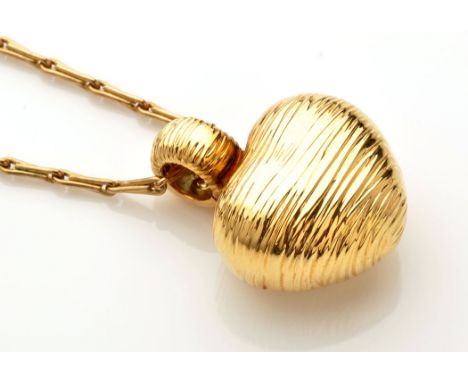 An 18ct. yellow gold hollow cast heart pattern pendant of textured design, set single ruby to bale, 3cms high; and a 9ct. yel