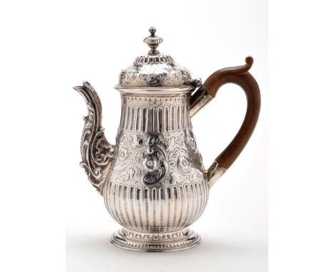 A George III coffee pot, by I.S., London 1770, baluster shaped with fluted and embossed floral design, the cartouche with mon