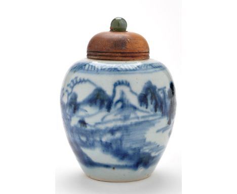 Small Chinese blue and white jar, painted with lakeland landscape, wooden cover with jade finial, on wooden stand, probably 1