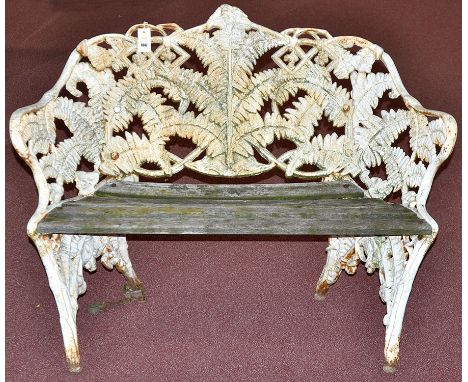 Manner of Coalbrookdale: a cast iron garden bench, decorated throughout with ferns and fitted lath wooden slatted seat, 24 x 