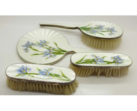 A four piece silver and guilloche enamel dressing table set, mirror and three brushes, some enamel a/f