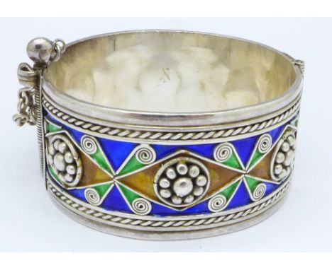 A white metal bangle with enamel decoration, possibly Russian, 71g, 29mm