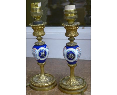 A pair of porcelain and enamel table lamps with crests