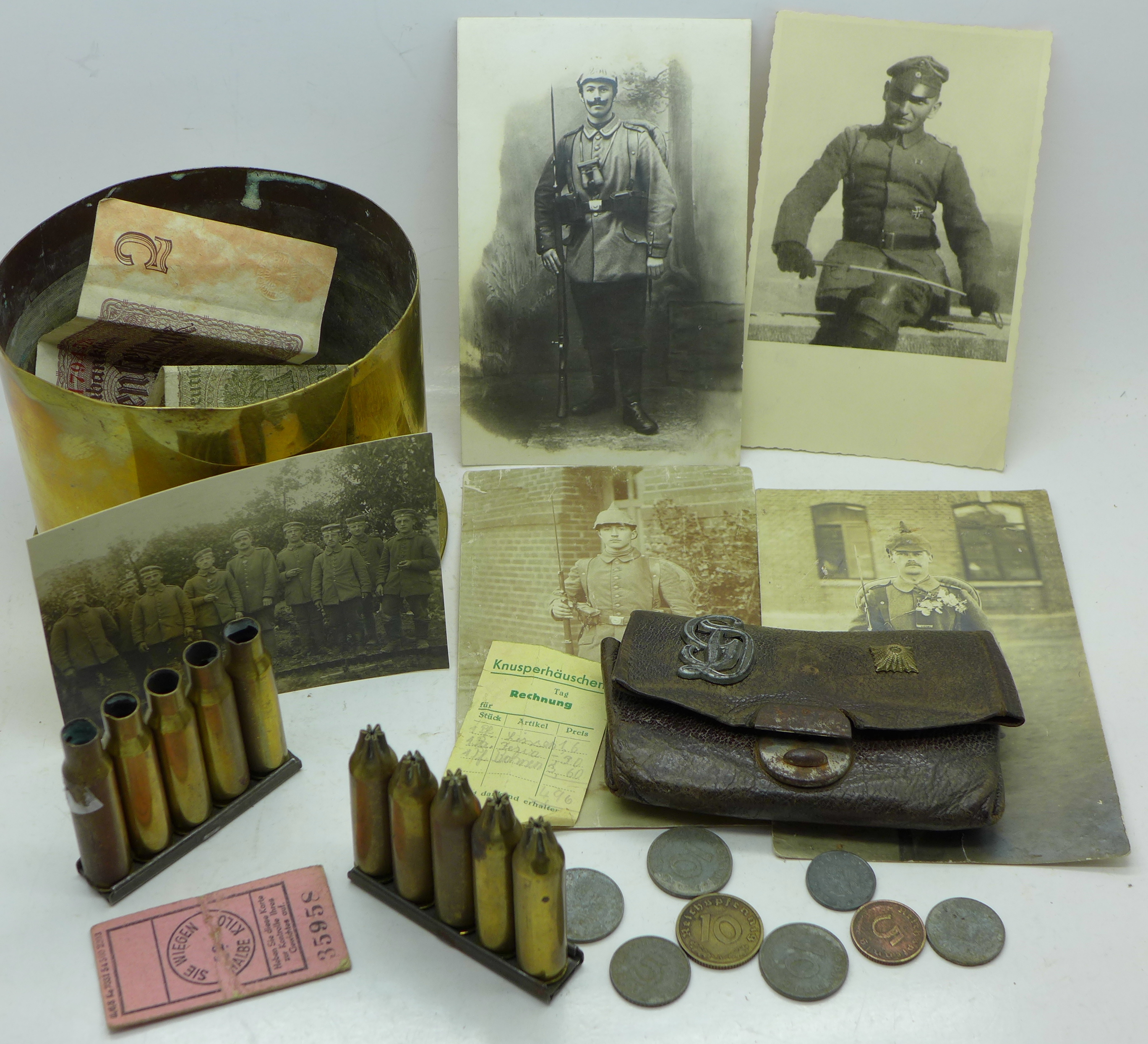 A military shell case marked 1915, other shell cases, five German