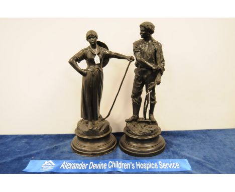 A pair of Victorian spelter figurines, male and female farm workers with tools in hand on naturalistic bases with plinth stan