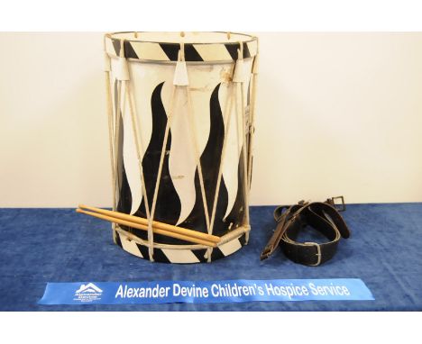 A Remo, Lefima Percussion drum, with black and white flames to body, strung, with sticks and leather carry sash, 55cm high x 