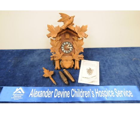 A Hubert Herr Black Forest cuckoo clock, having birds and chicks in nest decoration, 33 cm, pine cone weights IMPORTANT! REGA
