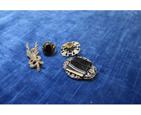 A silver and onyx floral brooch, together with a silver and marcasite brooch, a hematie ring and a Scottish Celtic citrine br