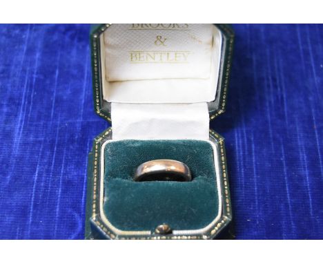 A yellow metal wedding band,  court shaped, ring size N IMPORTANT! REGARDING CONDITION REPORTS: Please note this is an auctio