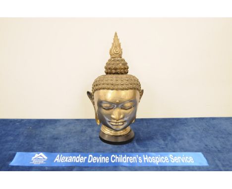 A moulded metal, hollow Thai Buddha head, on plinth, 46cm max high IMPORTANT! REGARDING CONDITION REPORTS: Please note this i