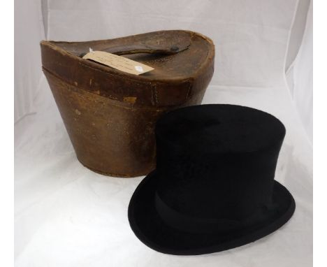 A 1910 Christie silk top hat in original leather case together with a vintage leather suitcase CONDITION REPORTS Some scuffs 