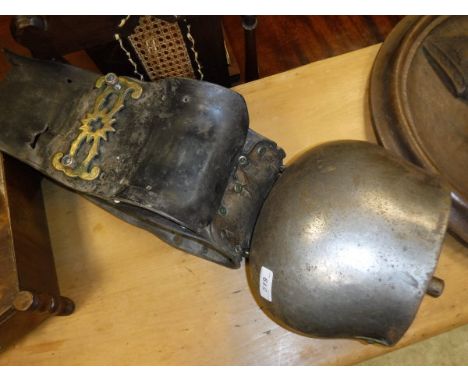 A large vintage cow bell with leather collar