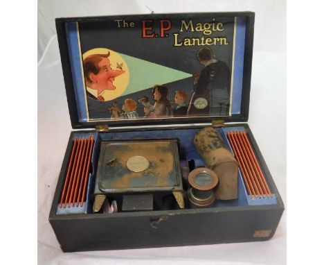 A boxed "The E.P. Magic Lantern" the lantern itself bearing medallion stamped "Standard E.P." with twelve slides, the box wit