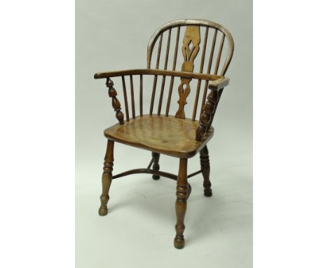 A 19th Century ash and elm low stick back elbow chair in the manner of Nicholson of Rockley on turned and ringed baluster sup