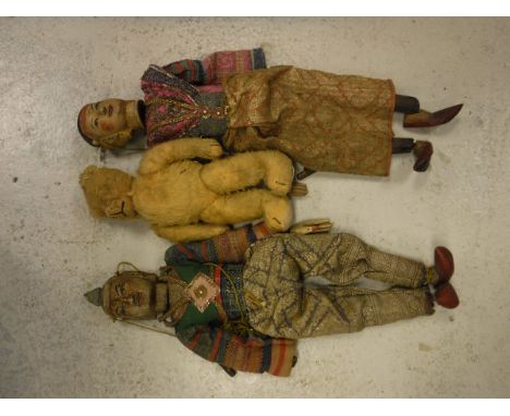 Two vintage Thai carved and painted wooden headed puppets with silver wire decorated clothing, together with a Dean's Ragbook