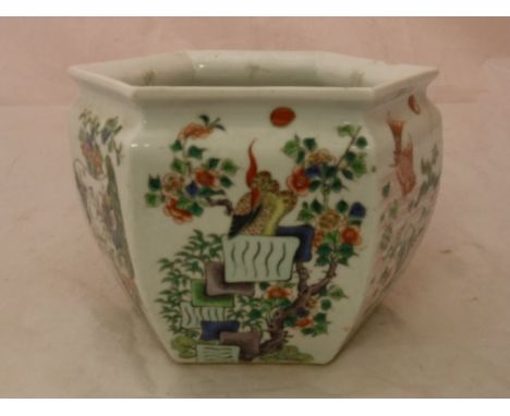A 19th Century Chinese Kangxi palette polychrome decorated jardiniere of hexagonal form each panel decorated with bird amongs