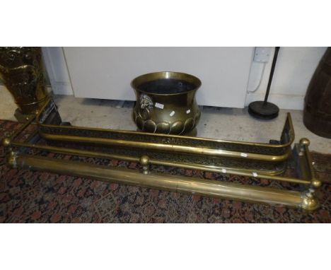 A 19th Century embossed brass baluster shaped jardinier in the Dutch style with brass lion mask ring handles, together with a