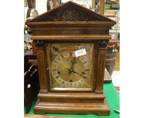 A late 19th Century oak cased mantle clock, the German musical movement with rectangular brass dial and silvered chapter ring