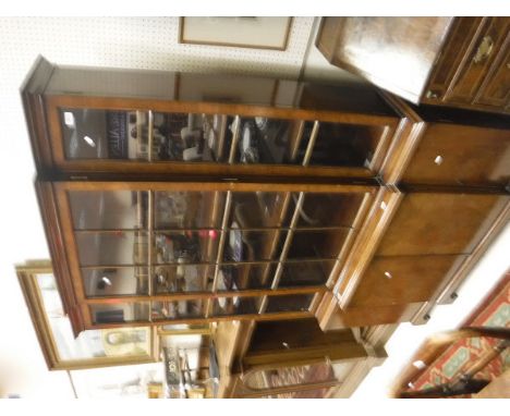 A 20th Century mahogany breakfront bookcase of small proportions in the George III taste, the upper section with three glazed