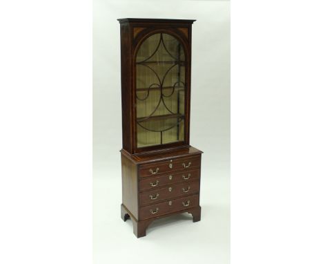 A late George III bachelor's bookcase chest, the upper section with moulded cornice over sunburst spandrels and domed door wi