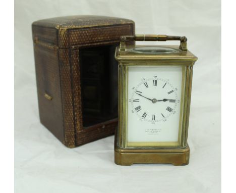 A Victorian gilt brass cased French carriage clock, the rectangular enamelled dial with Roman and Arabic numerals, inscribed 