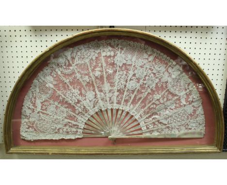 A 19TH CENTURY lacework and mother of pearl stick fan, framed and glazed CONDITION REPORTS The length of the guard stick is a