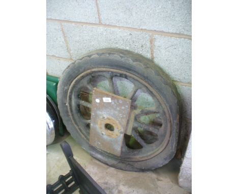 A Vintage 10 spoke iron car wheel and tyre.
