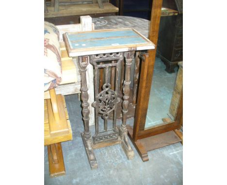 A Painted wooden and wrought iron stand , the rectangular top raised on ring turned baluster supports and iron open work brac