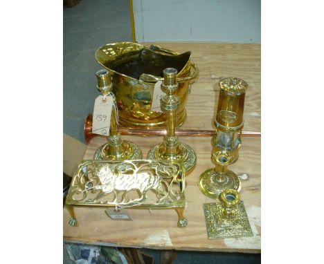 A Collection of brassware including a coal helmet, miners lamp, table candlestick with an embossed base, a pair of candlestic