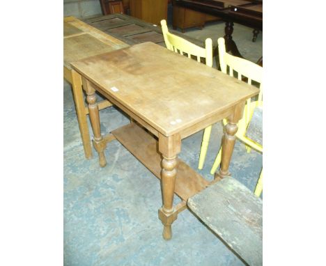 A Pine side table with a rectangular top on ring turned baluster supports and under shelf.