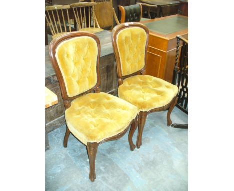 A Pair of Victorian walnut and golden velour button back side chairs with French curvilinear front legs.