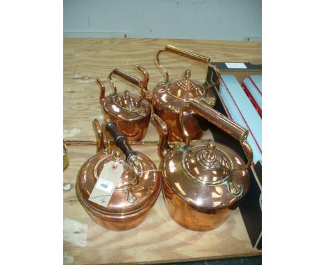 A Victorian copper kettle with an acorn finial , a smaller example and two others. (4)